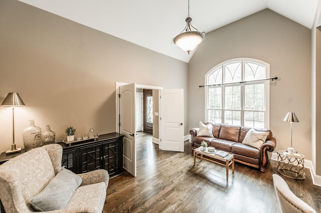 living room featuring dark hardwood / wood-style floors and vaulted ceiling