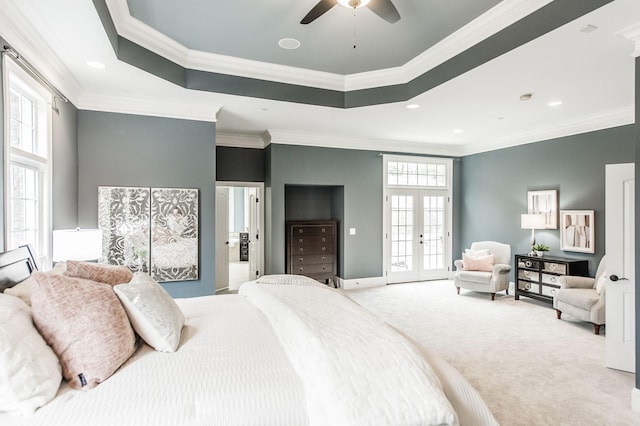 carpeted bedroom featuring access to exterior, ceiling fan, french doors, a tray ceiling, and ornamental molding