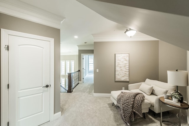 sitting room with light carpet and ornamental molding