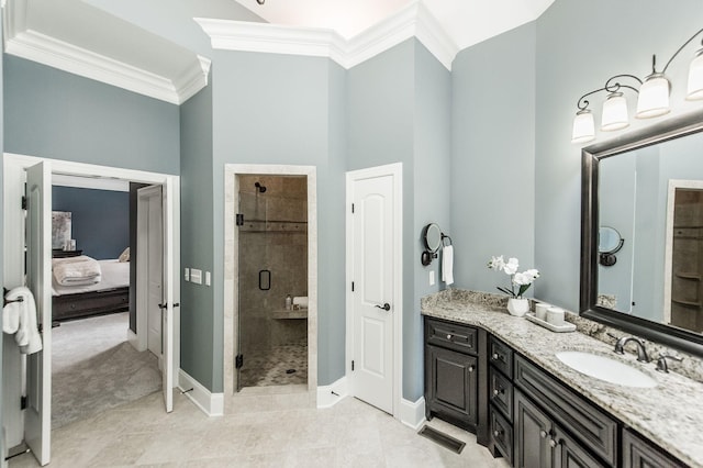 bathroom with vanity, an enclosed shower, and ornamental molding