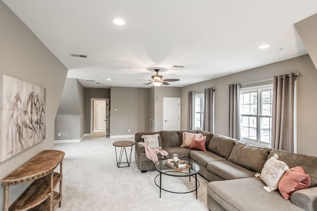 carpeted living room with ceiling fan