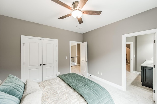 bedroom with ceiling fan, a closet, and light carpet