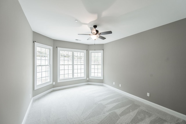 empty room featuring carpet flooring and ceiling fan