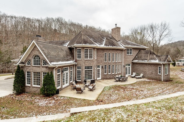 back of house with a patio area, an outdoor hangout area, and french doors