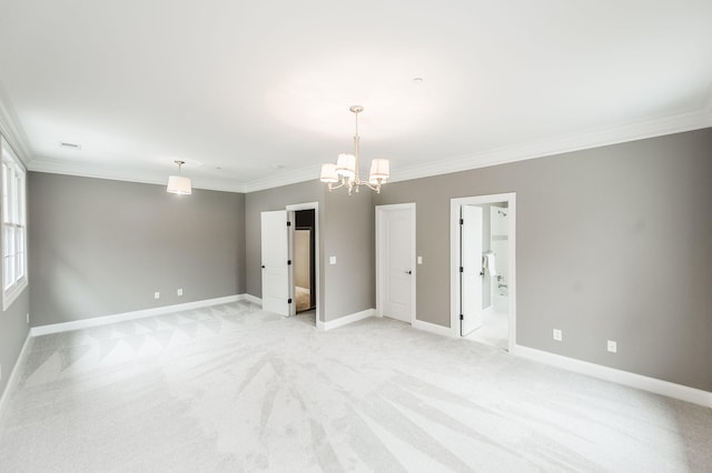 carpeted empty room featuring crown molding and an inviting chandelier