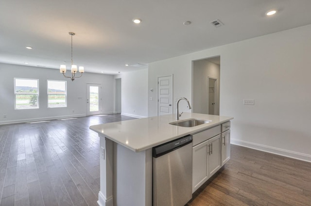 kitchen featuring an island with sink, stainless steel dishwasher, white cabinetry, and sink