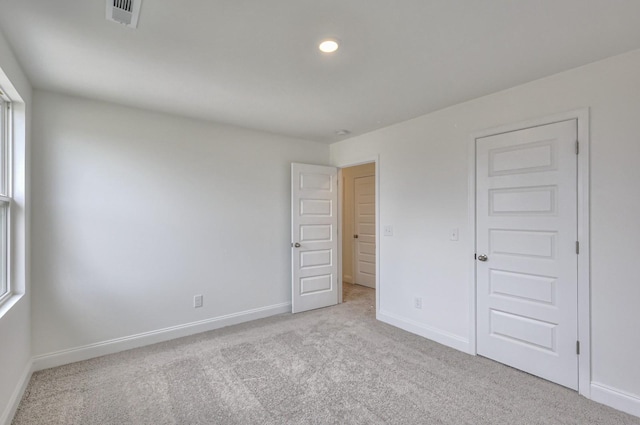 unfurnished bedroom featuring light colored carpet