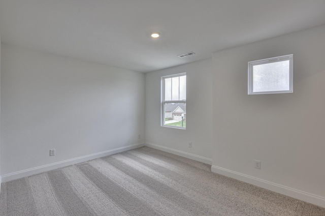 empty room featuring light carpet