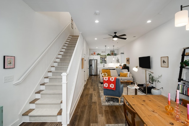 living room with ceiling fan and dark hardwood / wood-style flooring