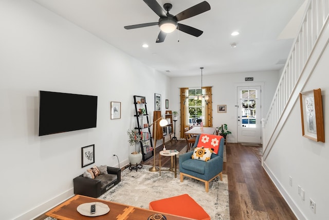 living room featuring dark hardwood / wood-style floors and ceiling fan