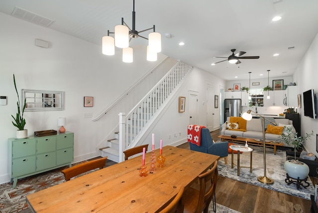 dining space with ceiling fan and dark wood-type flooring