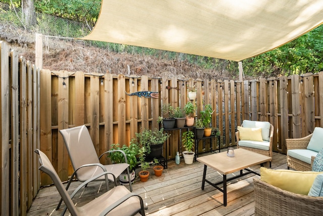 wooden balcony featuring an outdoor living space and a deck