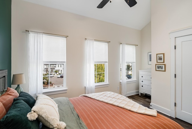 bedroom featuring dark hardwood / wood-style flooring, vaulted ceiling, and ceiling fan