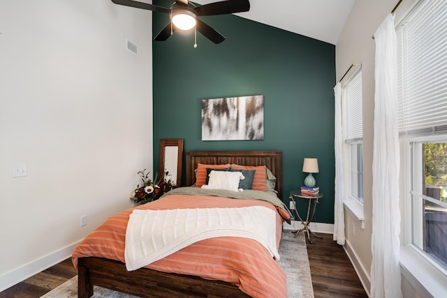 bedroom with dark hardwood / wood-style flooring, vaulted ceiling, and ceiling fan