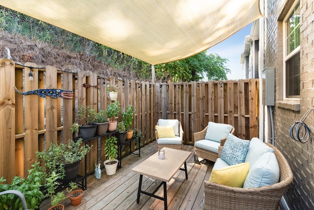 wooden deck with an outdoor living space