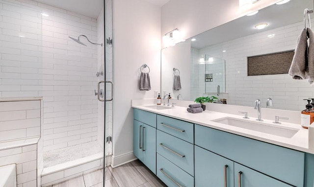 bathroom with walk in shower and vanity