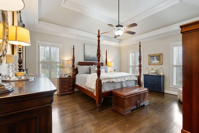 bedroom with a tray ceiling, ceiling fan, dark hardwood / wood-style flooring, and ornamental molding