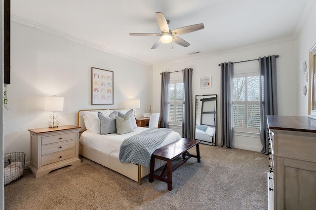 carpeted bedroom with ceiling fan and crown molding