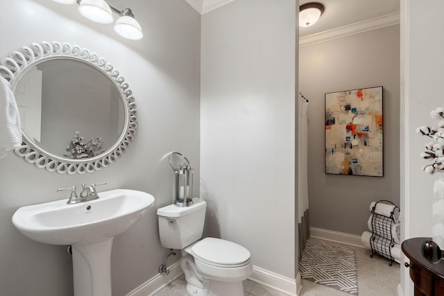 bathroom featuring tile patterned flooring, toilet, and ornamental molding