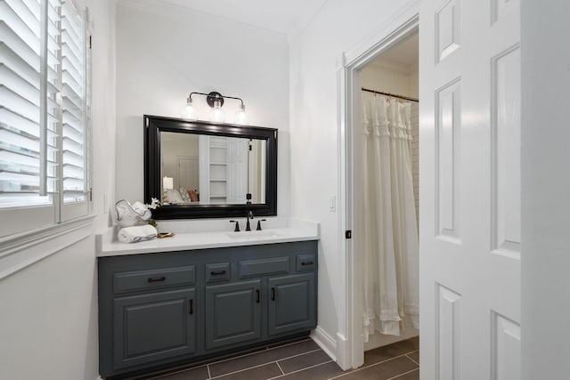 bathroom with vanity, tile patterned floors, and crown molding