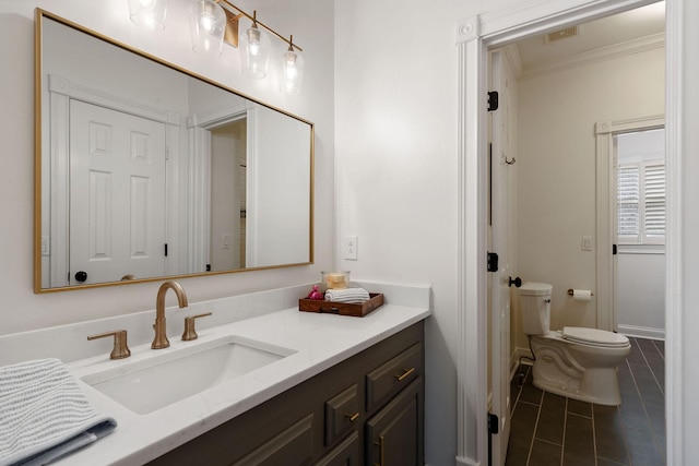 bathroom featuring tile patterned flooring, vanity, toilet, and ornamental molding