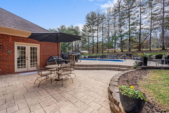 view of patio / terrace featuring a fenced in pool, grilling area, and french doors