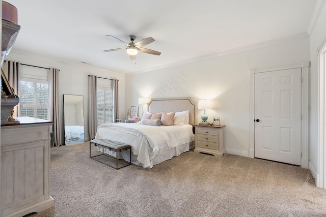 carpeted bedroom featuring ceiling fan and crown molding