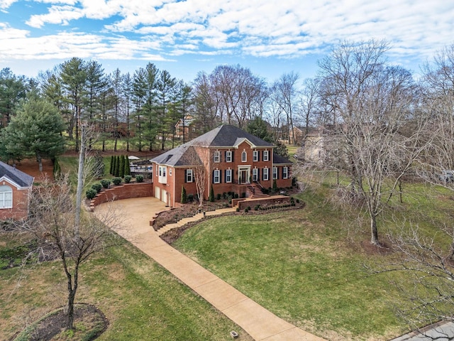 view of front of home with a garage and a front lawn