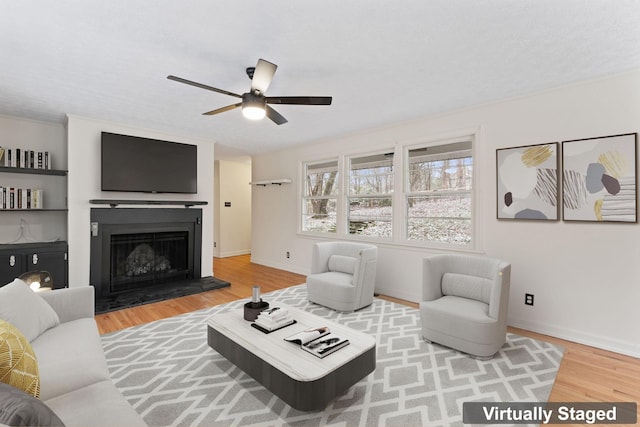 living room with wood-type flooring and ceiling fan