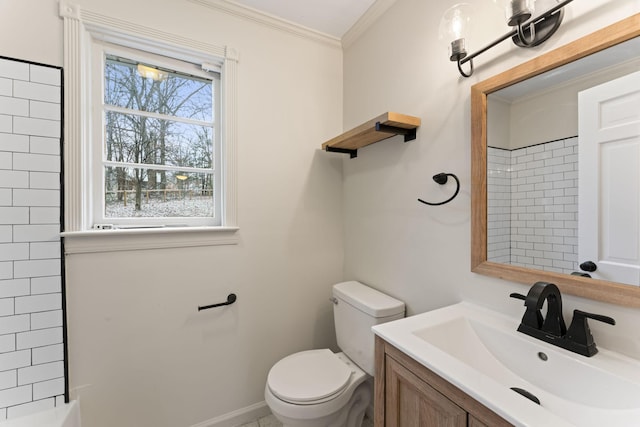 bathroom with vanity, toilet, ornamental molding, and a tile shower