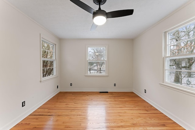 unfurnished room with ceiling fan, light wood-type flooring, and crown molding