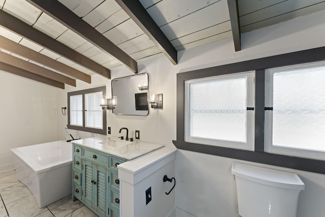 bathroom with a tub to relax in, vanity, wooden ceiling, vaulted ceiling with beams, and toilet