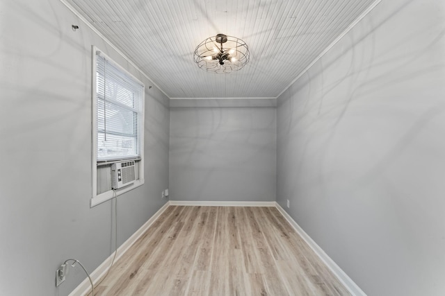 empty room featuring crown molding, cooling unit, and light hardwood / wood-style floors