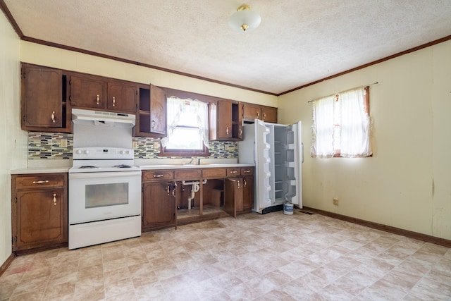 kitchen featuring a textured ceiling, crown molding, white electric range, and sink