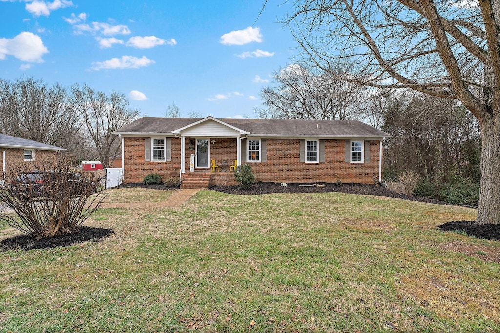 ranch-style house with a front lawn