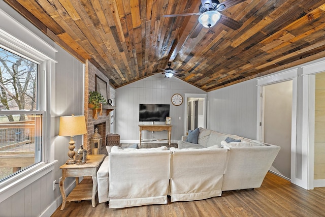 living room with lofted ceiling, wooden walls, a fireplace, wood-type flooring, and wood ceiling