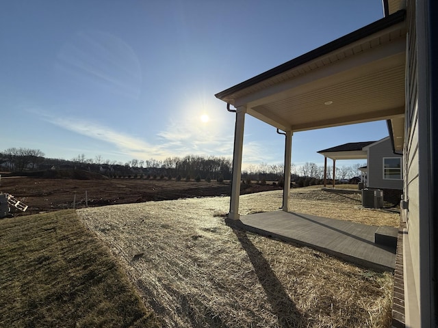 view of yard with cooling unit and a rural view