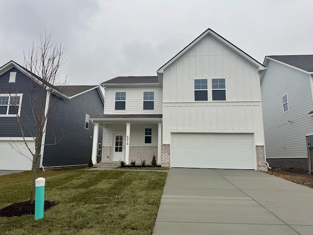 view of front of home with a front yard, a porch, and a garage