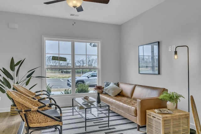 living room with light hardwood / wood-style floors and ceiling fan