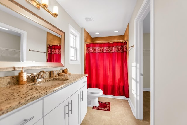 full bath with tile patterned floors, curtained shower, a spacious closet, and vanity