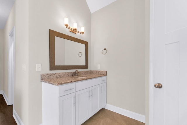 bathroom with baseboards and vanity