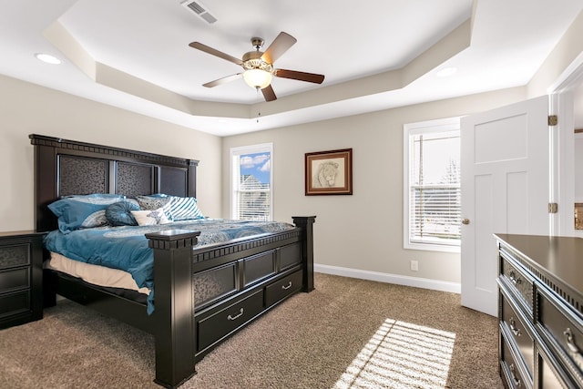 bedroom with visible vents, baseboards, carpet, a tray ceiling, and recessed lighting