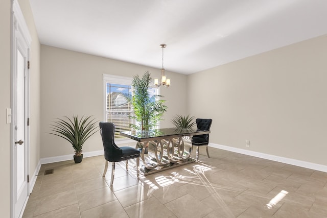 dining room with light tile patterned floors, a notable chandelier, visible vents, and baseboards