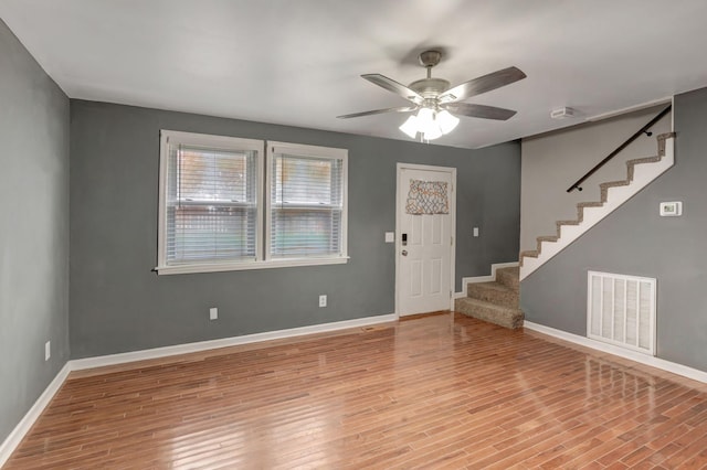 foyer entrance with light hardwood / wood-style flooring and ceiling fan