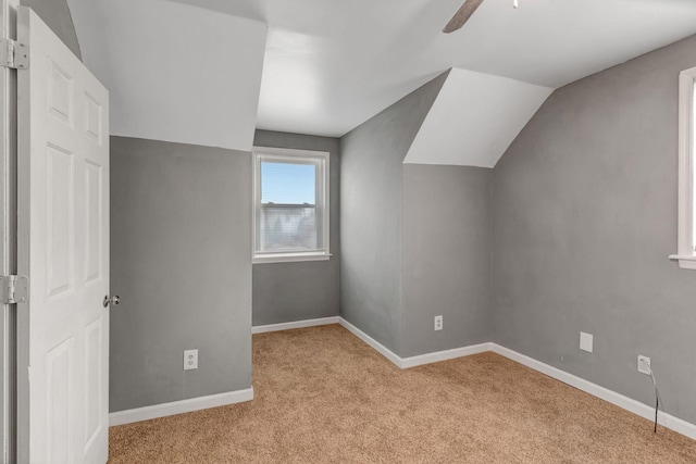 bonus room featuring light carpet, vaulted ceiling, and ceiling fan