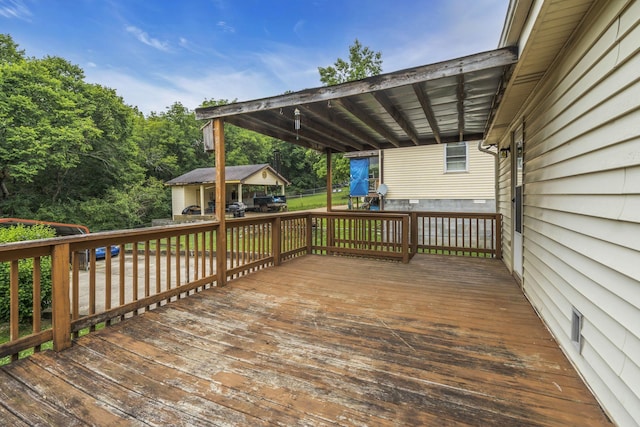 wooden deck featuring a carport