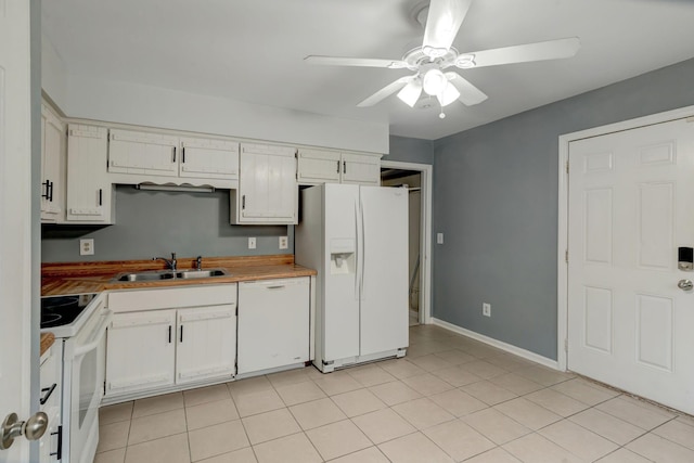 kitchen featuring white appliances, white cabinets, sink, ceiling fan, and light tile patterned floors