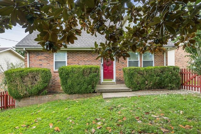 obstructed view of property featuring a front lawn