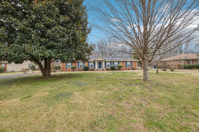 ranch-style home with a front lawn