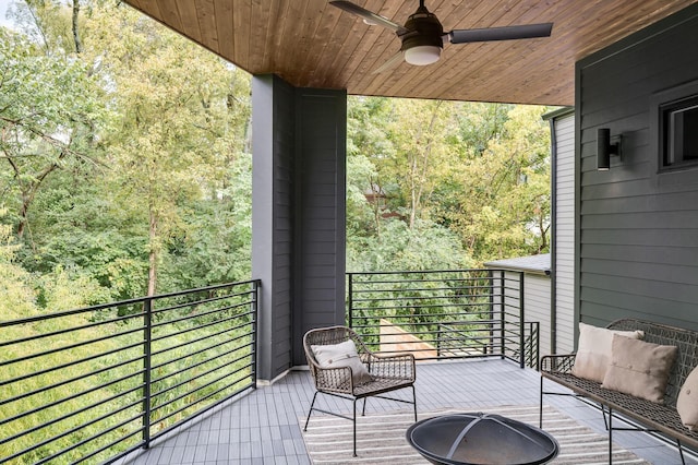 balcony featuring a fire pit and ceiling fan